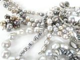 many different types of pearls on a white surface