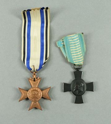 two medals are placed next to each other on a gray surface