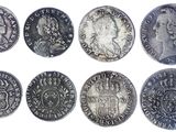 six different types of silver coins are shown on a white background