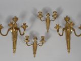 three brass wall sconces on a white background with a white background