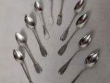 a lot of spoons arranged in a circle on the table