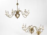 a pair of antique brass chandeliers with glass shades