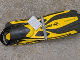 a yellow and black surfboard laying on the ground
