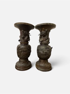 two vases that are sitting side by side on a white surface