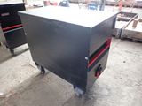 an image of a metal workbench with a red drawer