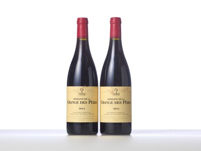 two bottles of red wine sitting on top of a table