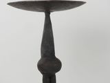 a close up of a metal candle holder on a white background
