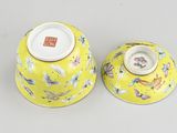 pair of yellow and white vases with butterflies on them