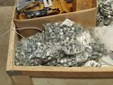 a wooden box filled with assorted metal parts
