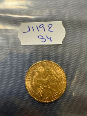 a close up of a gold coin with a label on it