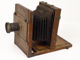 an old wooden camera that is sitting on a table