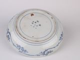 a blue and white bowl on a white surface