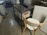 a small table with a chair next to it in a kitchen