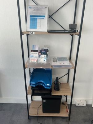 a shelf that has a laptop and other items on it