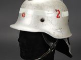 an old fireman ' s helmet on a black mannequin head