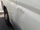 a white van that is parked on the side of the road