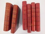 six red books sitting on top of each other on a white surface