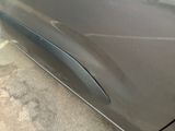 a close up of a car door handle with a hole in it