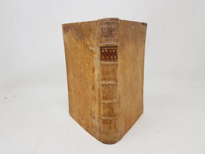 an old book sitting on top of a white table