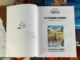 several books on a table with a drawing of a man riding a horse