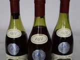 three bottles of wine that are sitting on a table