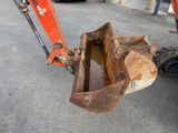 a small excavator that is sitting on the ground