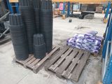 many stacks of black plastic cups on a pallet