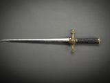 a close up of a knife on a table with a black background