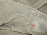 a close up of a military jacket with a red spot on it