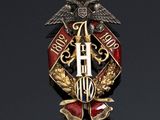 an image of a gold and red broochle with two birds on it