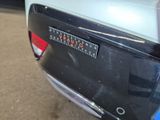 a rear end of a car with a sticker on it