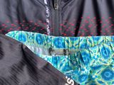 the adidas jacket has a blue and green floral pattern on it