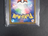 a close up of a pokemon card in a plastic case