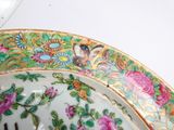 a close up of a plate with flowers and birds on it