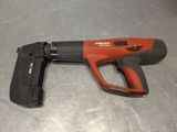 a red and black cord nail gun sitting on top of a table