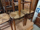 two wooden chairs sitting next to each other in a room