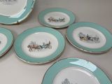 several plates with a horse drawn carriage on them sitting on a table