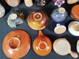 many different types of pottery sitting on a table