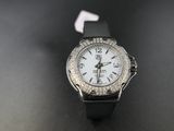 a close up of a watch with a white face on a black surface