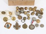 a wooden box filled with old and antique buttons