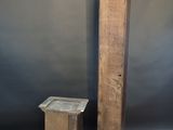 a tall wooden pole next to a small wooden table