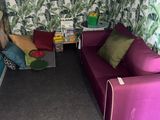 a room with two couches and a table in it