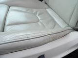a white leather seat in the back of a car
