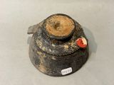 a black and brown vase with a red heart on it