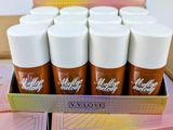 a box of lip glosses in various shades of pink, orange, and yellow