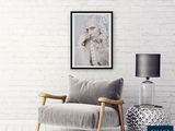 a picture of a woman sitting on a chair in a living room