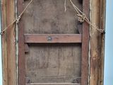 a picture of an old wooden frame with a tag on it