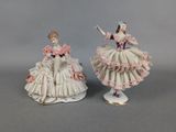pair of porcelain figurines of a woman in a dress and a man in a tuxedo