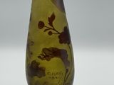 a yellow vase with a picture of a bird on it