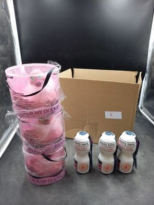 a box of pink donuts and six bottles of soda